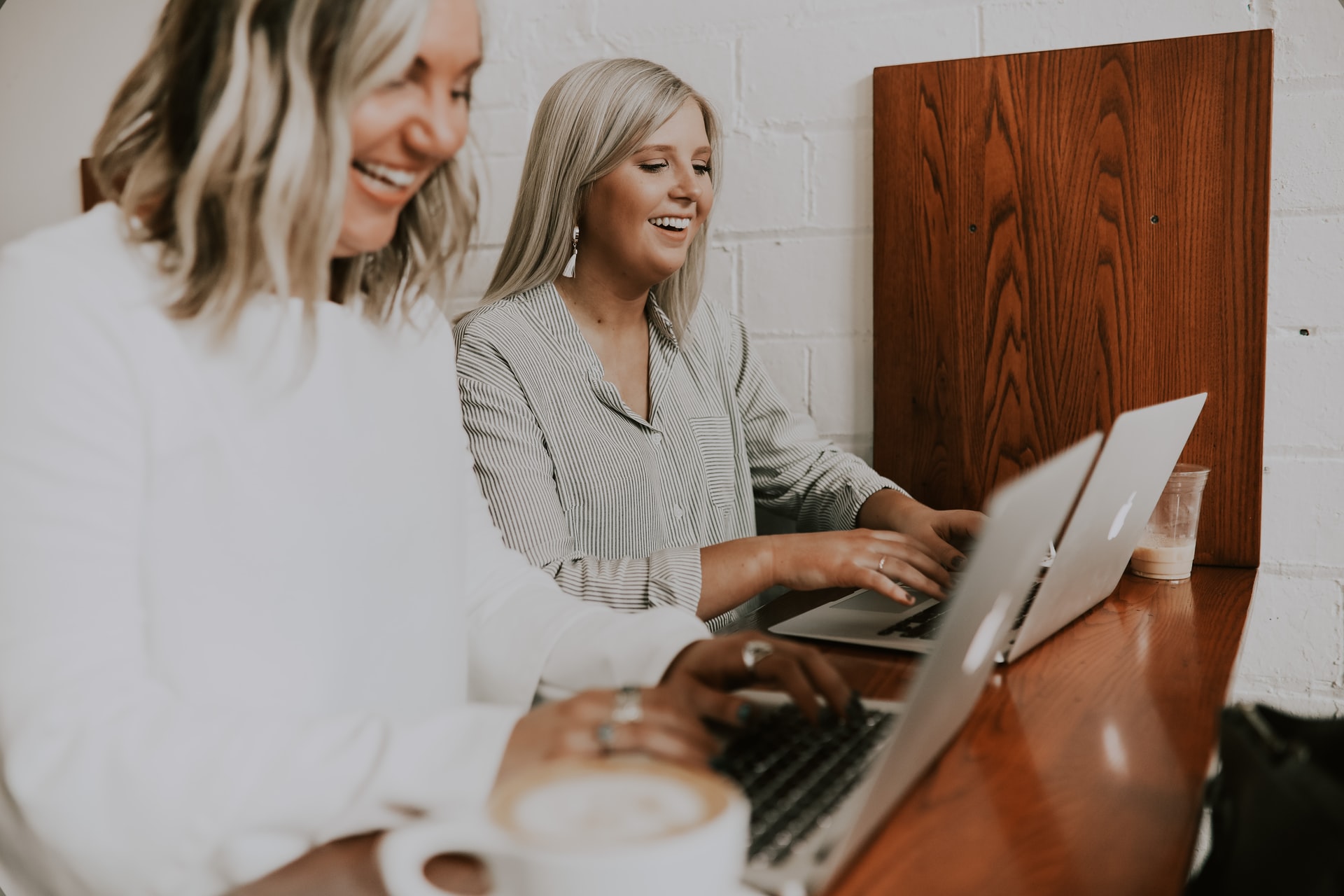 Two women using laptop